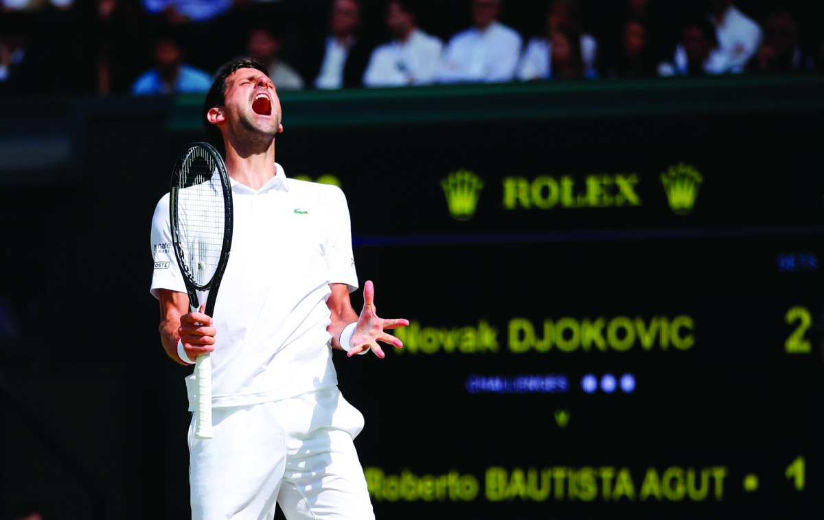 Serbia's Novak Djokovic reacts after a point against Spain's Roberto Bautista Agut during their men's singles semi-final match on day 11 of the 2019 Wimbledon Championships at The All England Lawn Tennis Club in Wimbledon, southwest London, on July 12, 20