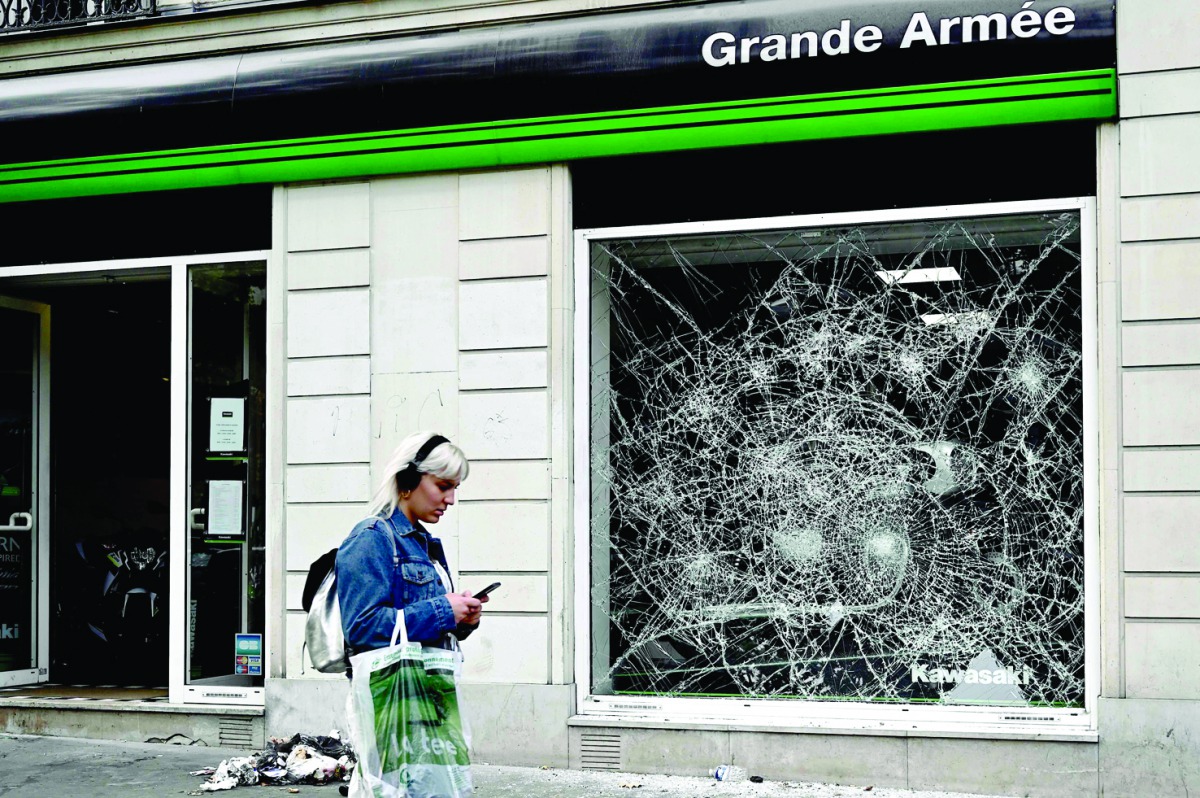 This picture taken on July 12, 2019, shows a broken window on the Grande Armee street, near the Arc de Triomphe in Paris where Algerian supporters celebrated the victory of their team during the 2019 Africa Cup of Nations (CAN) quarter final football matc