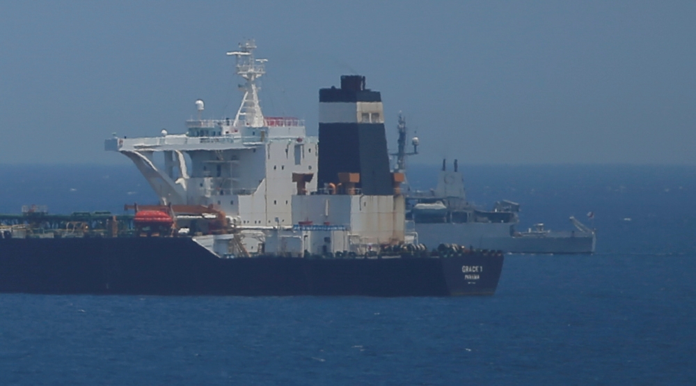 FILE PHOTO: A British Royal Navy patrol vessel guards the oil supertanker Grace 1, that's on suspicion of carrying Iranian crude oil to Syria, as it sits anchored in waters of the British overseas territory of Gibraltar, historically claimed by Spain, Jul