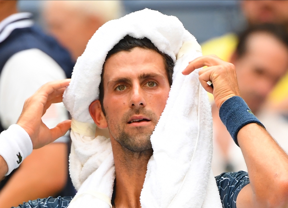Novak Djokovic of Serbia coping with the extreme heat while playing Marton Fucsovics of Hungary in a 2018 match. Credit: Robert Deutsch-USA TODAY Sports