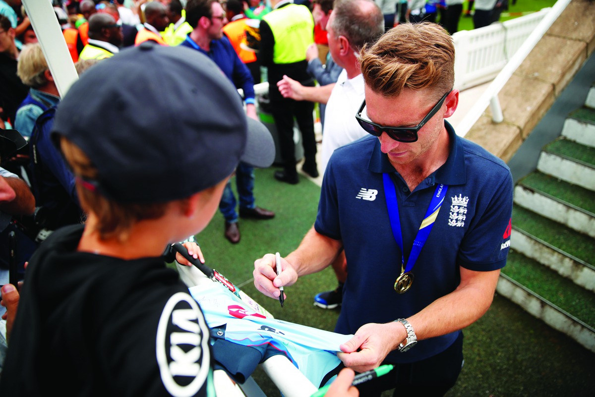 England's Jos Buttler signs his autograph for a fan during the celebrations. (Action Images via Reuters/Andrew Boyers) 