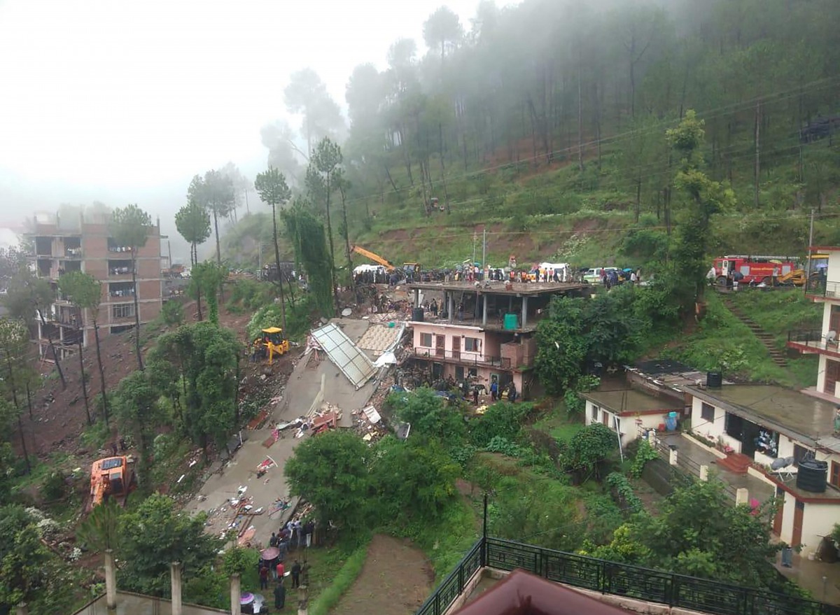 Indian rescuers work on a site after a multi-storey building collapsed following heavy rains near Kumarhatti, in Himachal Pradesh’s Solan district on At least eight people were killed after a house collapsed in northern India following heavy monsoon rain 