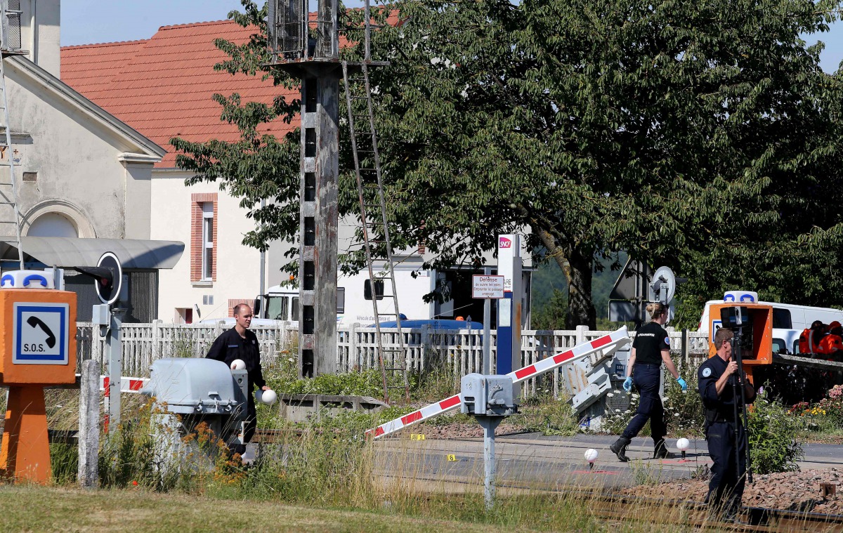 French gendarmes stand at a level crossing on July 15, 2019, after a car and a TER regional express train crashed at the exit of the train station in Avenay-Val-d'Or, near Reims, northeastern France. AFP / Francois Nascimbeni