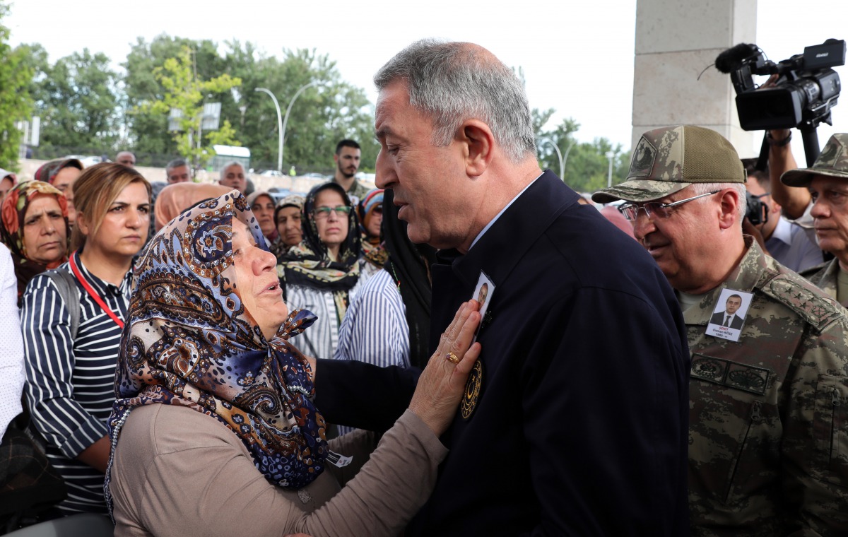 Turkish National Defense Minister Hulusi Akar condoles with Sidika Kose (L), mother of Turkish diplomat Osman Kose, who was martyred in an armed attack in Iraq's Erbil, during the funeral ceremony at Ahmet Hamdi Akseki Mosque in Ankara, Turkey on July 18,