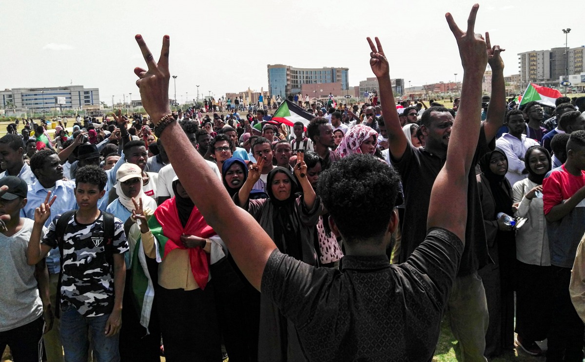 Sudanese protesters chant slogans and wave national flags as they march in the capital Khartoum's Green Square on July 18, 2019, as they honour comrades killed in the months-long protest movement that has rocked the country. AFP