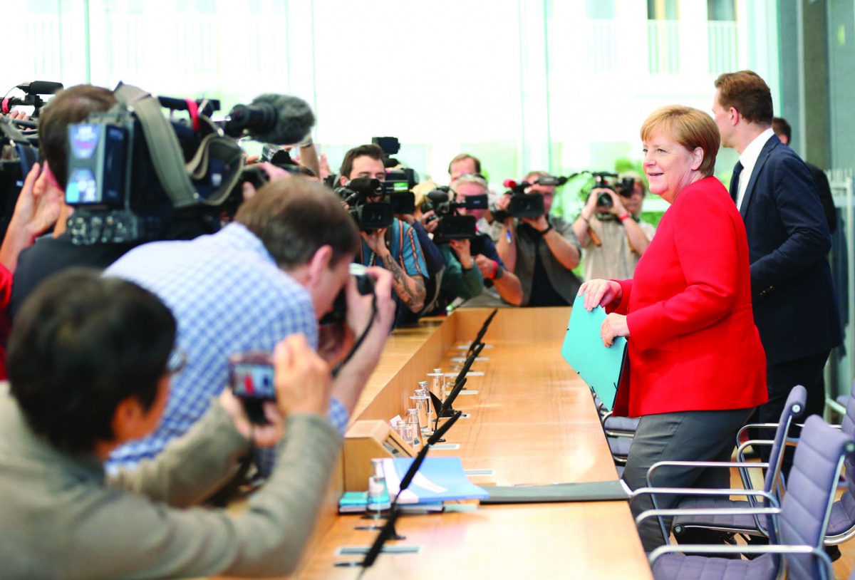 German Chancellor Angela Merkel (R) faces photographers at the start of her summer press conference at Federal Press Conference in Berlin, Germany on July 19, 2019. (Cüneyt Karada? - Anadolu Agency)