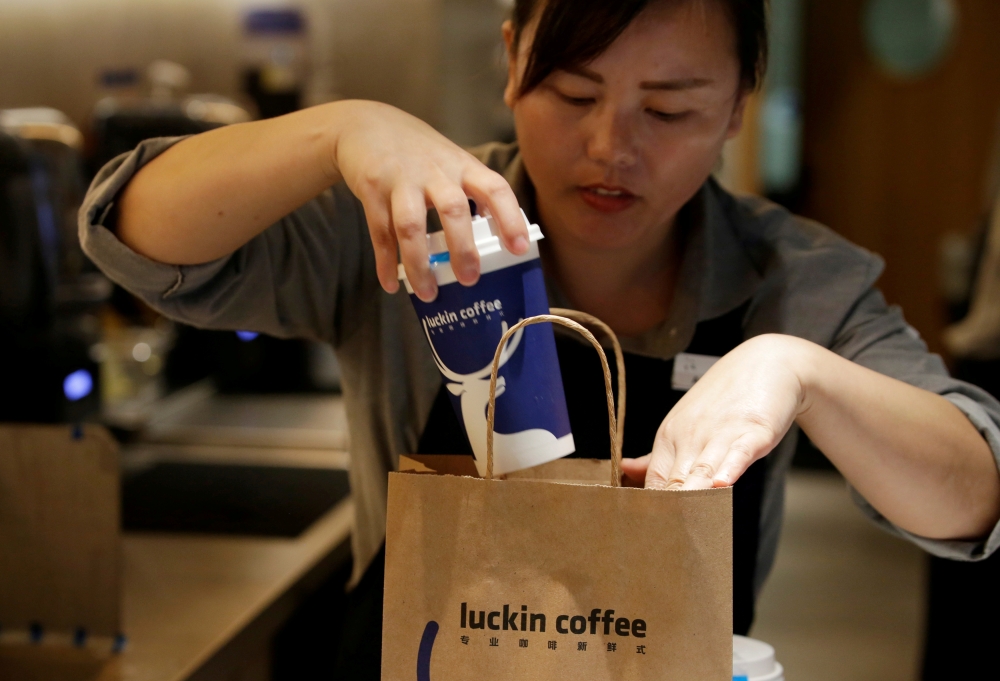 File photo of a barista packing a coffee for online sales at a Luckin Coffee store in Beijing, China July 17, 2018. REUTERS/Jason Lee/File Photo