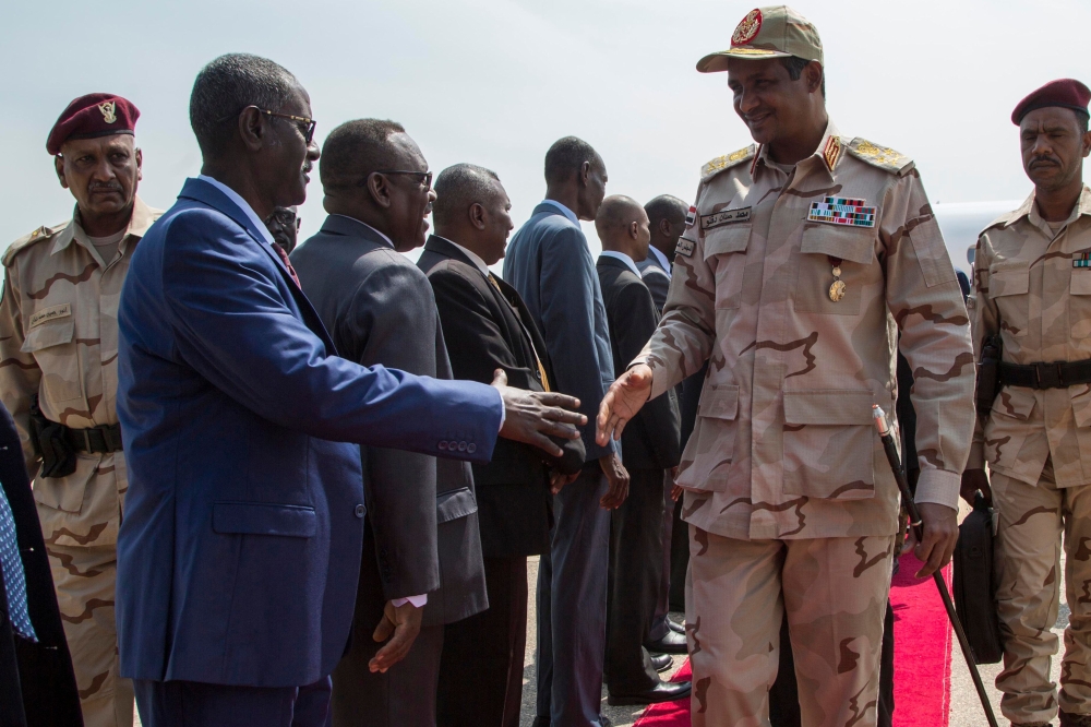 Sudan deputy Head of Military Council Mohamed Hamdan Dagalo (2nd-R) is welcomed at Juba international airport upon his arrival from Khartoum on July 27, 2019 in South Sudan. (AFP / AKUOT CHOL)