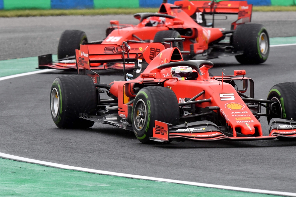 Ferrari's German driver Sebastian Vettel steers his car in front of Ferrari's Monegasque driver Charles Leclerc during the second practice session of the Formula One Hungarian Grand Prix at the Hungaroring circuit in Mogyorod near Budapest, Hungary, on Au