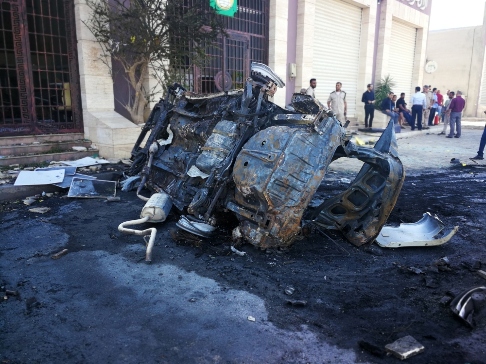 People gather at the site where a car bomb exploded in Benghazi, Libya August 10, 2019. REUTERS/Ayman al-Werfalli 