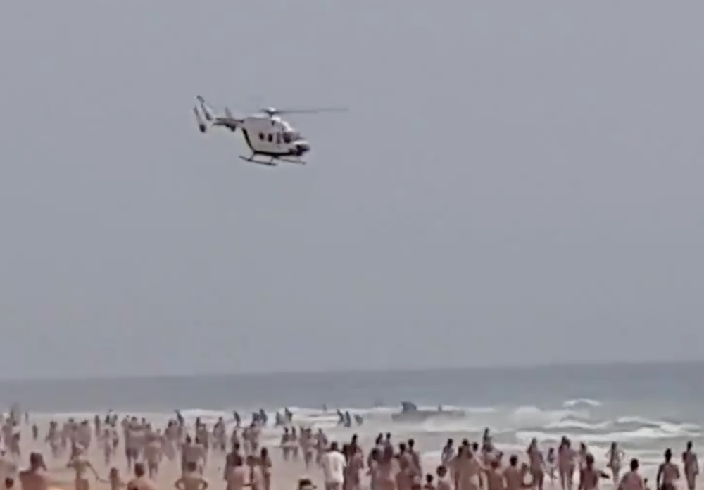 A dinghy carrying a group of migrants arrives to the beach of El Palmar in southern Spain, Cadiz, Spain August 7, 2019 in this still image obtained from social media video on August 8, 2019. ALBERTO BARRIOS