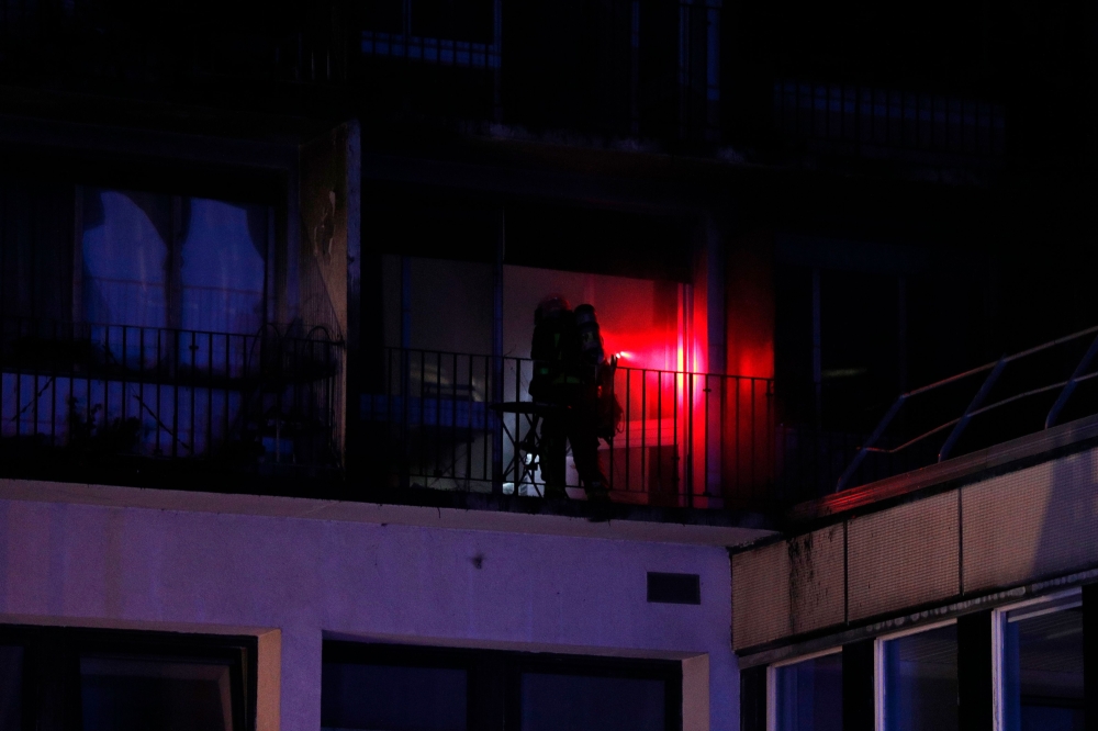 A firefighter works at Henri-Mondor Hospital in Creteil, the suburbs of Paris, early on August 22, 2019, after a fire broke out in the nursing students' residence leaving one dead and multiple wounded. / AFP / GEOFFROY VAN DER HASSELT