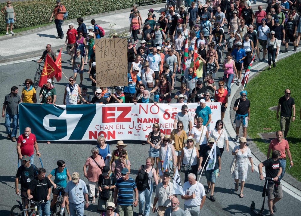 Demonstrators take part in a march in Irun on August 24, 2019, to protest against the annual G7 Summit attended by the leaders of the world's seven richest democracies, Britain, Canada, France, Germany, Italy, Japan and the United States in Biarritz from 