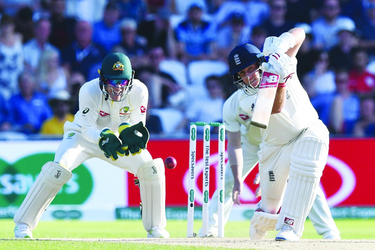 England's captain Joe Root (R) plays a shot as Australia's captain Tim Paine (L) keeps wicket during play on the third day of the third Ashes cricket Test match between England and Australia at Headingley in Leeds, northern England, on August 24, 2019. AF