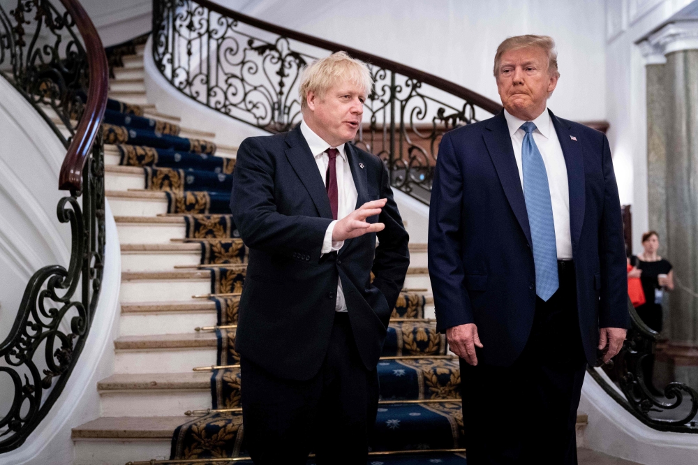 US President Donald Trump (R) and Britain's Prime Minister Boris Johnson speak before a working breakfast at the G7 Summit in Biarritz, France on August 25, 2019, on the second day of the annual G7 Summit attended by the leaders of the world's seven riche