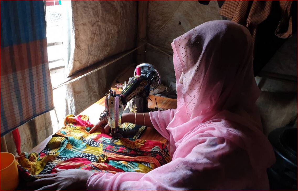 Shofika Begum, a Rohingya who was raped two years ago in Myanmar and today leads a group of female tailors in the refugee camps in South East Bangladesh who sell clothes for a living, stitches a dress at her home on August 5, 2019. Thomson Reuters Foundat
