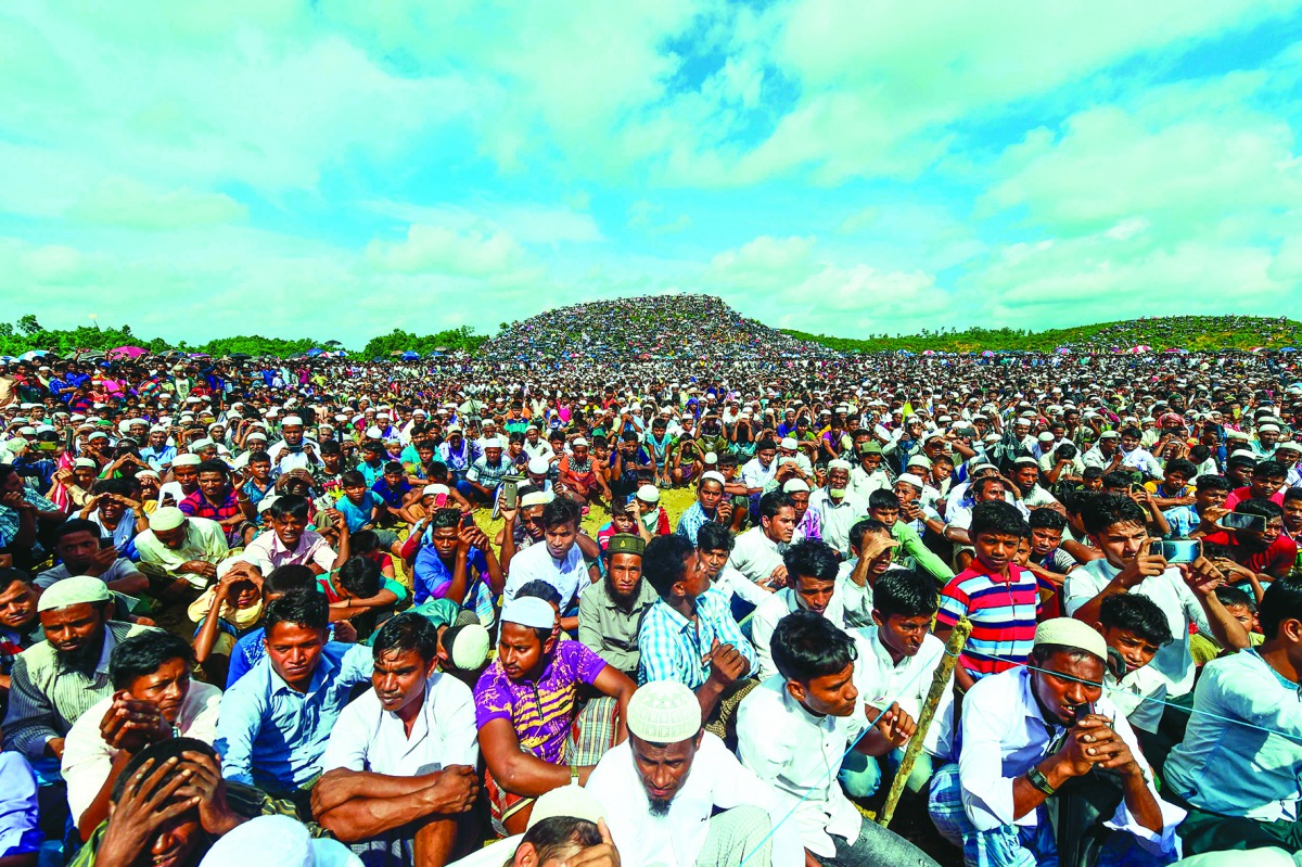 Rohingya refugees attend a ceremony organised to remember the second anniversary of a military crackdown that prompted a massive exodus of people from Myanmar to Bangladesh, at the Kutupalong refugee camp in Ukhia on August 25, 2019.  AFP / Munir Uz Zaman