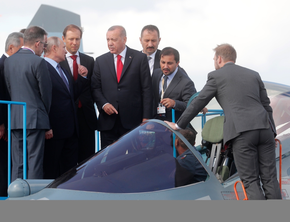 Russian President Vladimir Putin (3rd L) and his Turkish counterpart Recep Tayyip Erdogan (4th R) inspect Sukhoi Su-57 fifth-generation fighter during the MAKS-2019 International Aviation and Space Salon opening ceremony in Zhukovsky outside Moscow on Aug