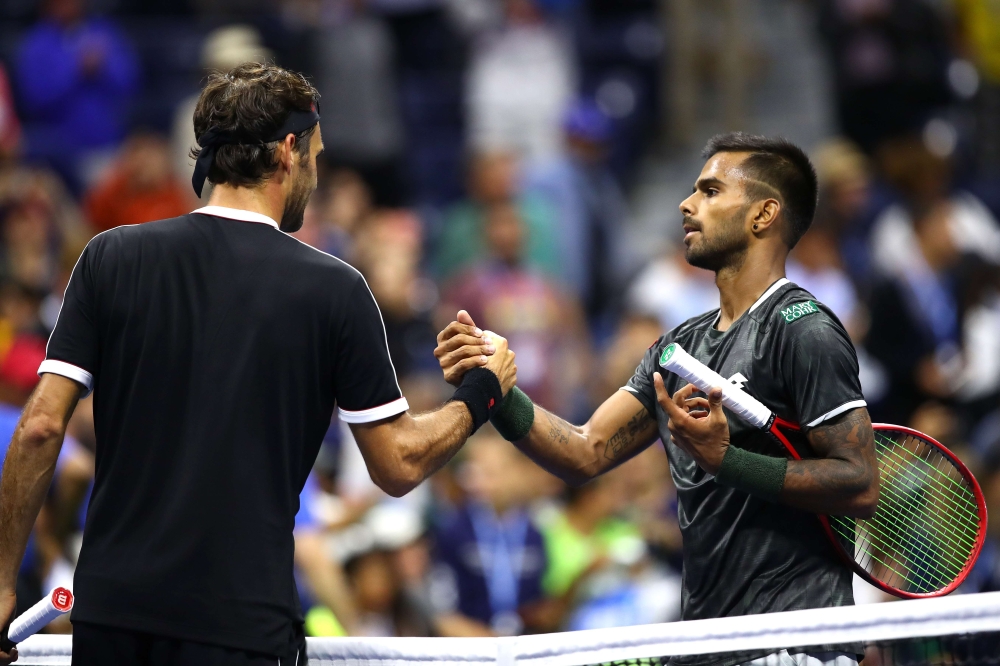 Roger Federer of Switzerland shakes hands with Sumit Nagal of India after their Men's Singles first round match on day one of the 2019 US Open at the USTA Billie Jean King National Tennis Center on August 26, 2019 in the Flushing neighborhood of the Queen