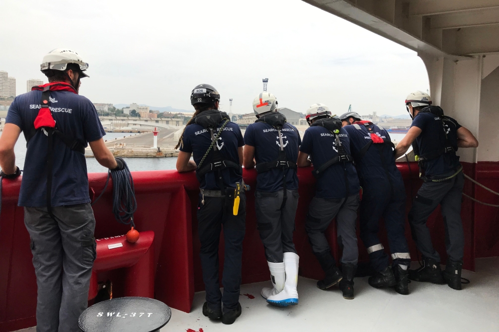 Members of the crew of the Ocean Viking rescue ship, jointly operated by French NGOs SOS Mediterranee and Medecins sans Frontieres (MSF - Doctors Without Borders), arrive in the port of Marseille on August 27, 2019, after 23 days of search-and-rescue oper