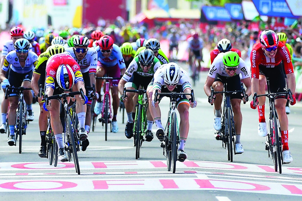 Team Deceuninck rider Netherlands' Fabio Jakobsen (L), Team Bora rider Ireland's Sam Bennett (C) and Team Sunweb rider Germany's Max Walscheid (R) cross the finish of the fourth stage of the 2019 La Vuelta cycling tour of Spain, a 175,5 km route from Cull