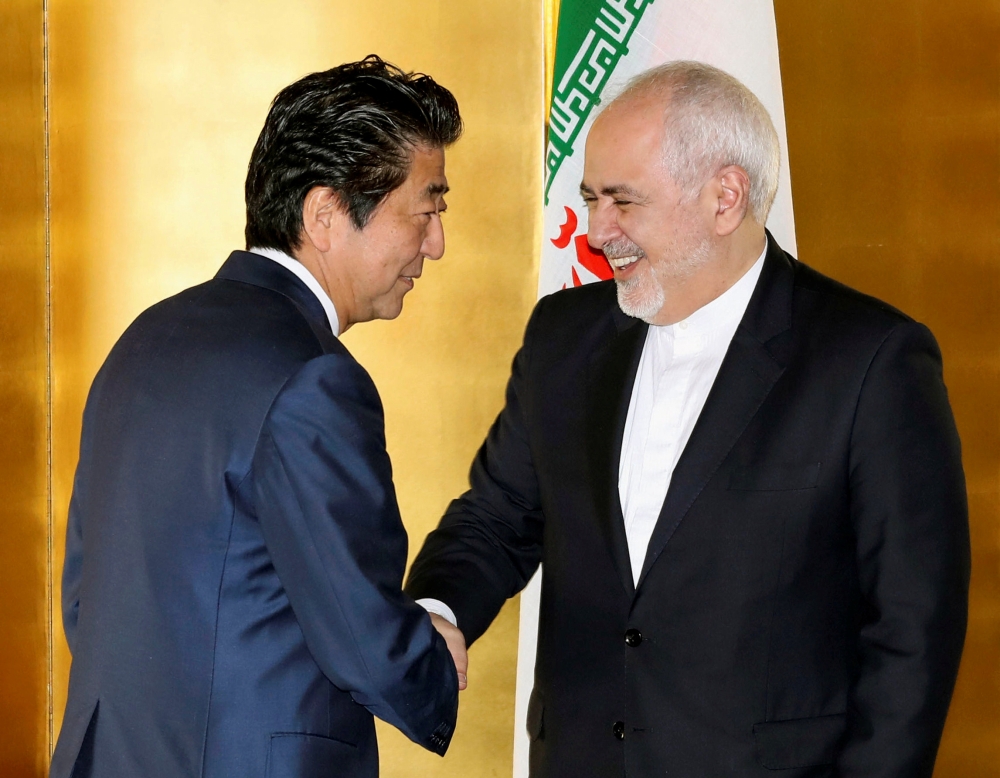 Japan's Prime Minister Shinzo Abe greets Iran's Foreign Minister Mohammad Javad Zarif at the start of their bilateral meeting in Yokohama, south of Tokyo, Japan August 28, 2019, in this photo released by Kyodo. Kyodo/via REUTERS 