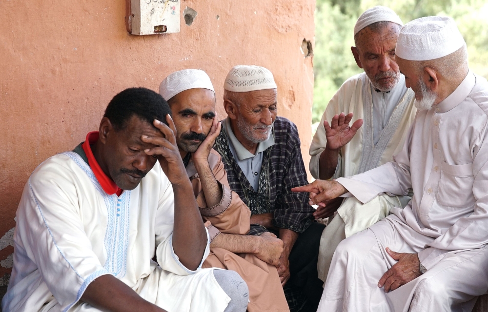 Relatives of victims killed during a flash flood mourn in the southern Moroccan city of Tizert, on August 29, 2019.  AFP 