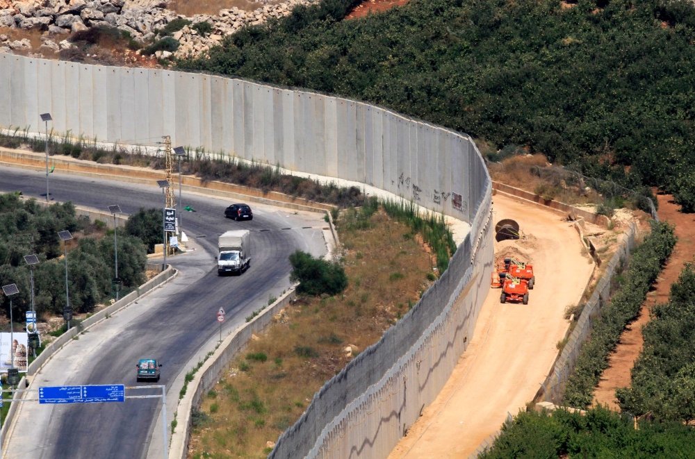 A view of the barrier along the border between Lebanon and Israel, with the Lebanese village of Kfar Kila on the left and the Israeli town of Metula on the right on August 29, 2019. AFP / Mahmoud Zayyat 