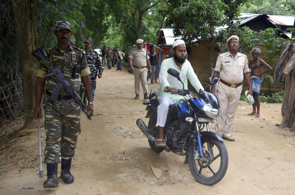 Security personnel patrol on a road ahead of the publication of the final draft of the National Register of Citizens (NRC) at Kachari Para village, in Hojai district, of Assam August 30, 2019. Reuters/Anuwar Hazarika
 