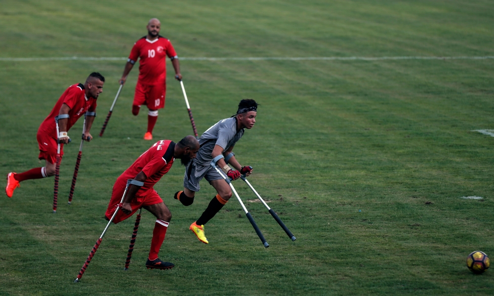 Palestinian amputees take part in a football match, part of a local tournament for amputees, in Gaza City on August 27, 2019.  AFP /Mahmud Hams 