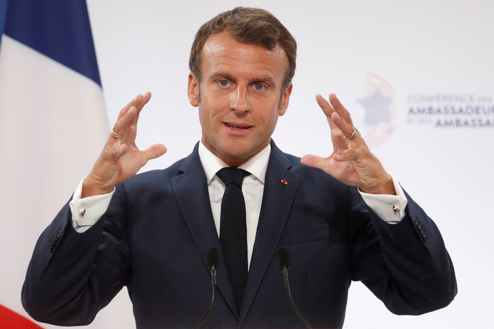 FILE PHOTO: French President Emmanuel Macron delivers a speech at the Elysee Palace in Paris, France August 27, 2019. Yoan Valat/Pool/File Photo	