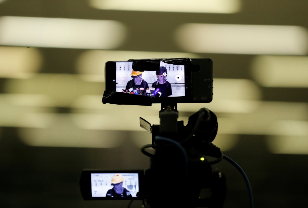 Protesters holding a news conference are displayed in camera and phone screens in Hong Kong, China, September 4, 2019. Reuters/Amr Abdallah Dalsh
 