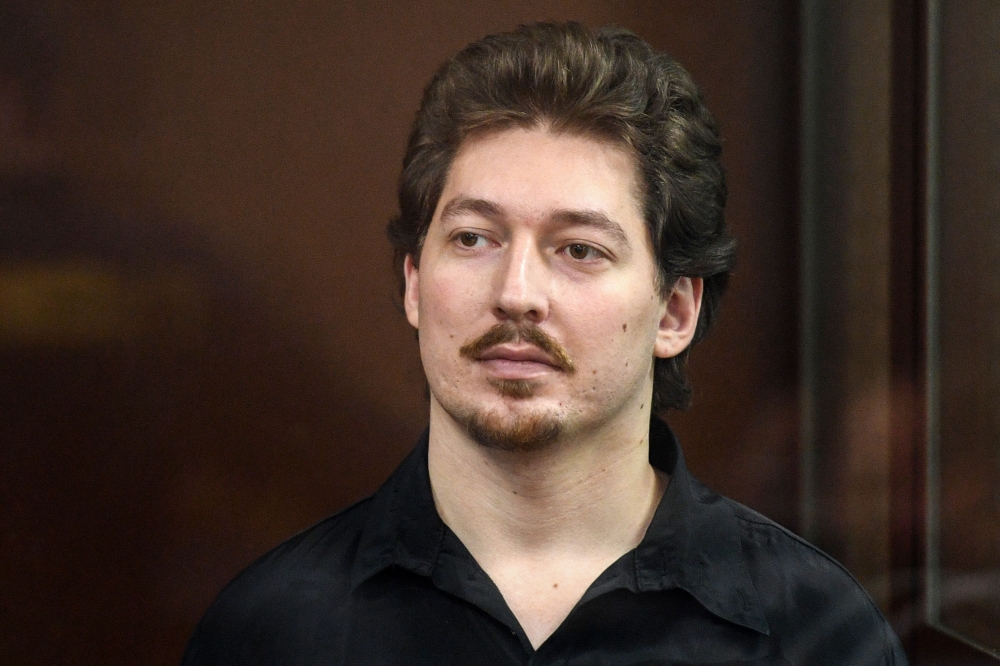 Russian anti-government activist, student Kirill Zhukov, stands inside the defendants' box during a hearing at a court in Moscow on September 4, 2019. AFP / Kirill Kudryavtsev
 