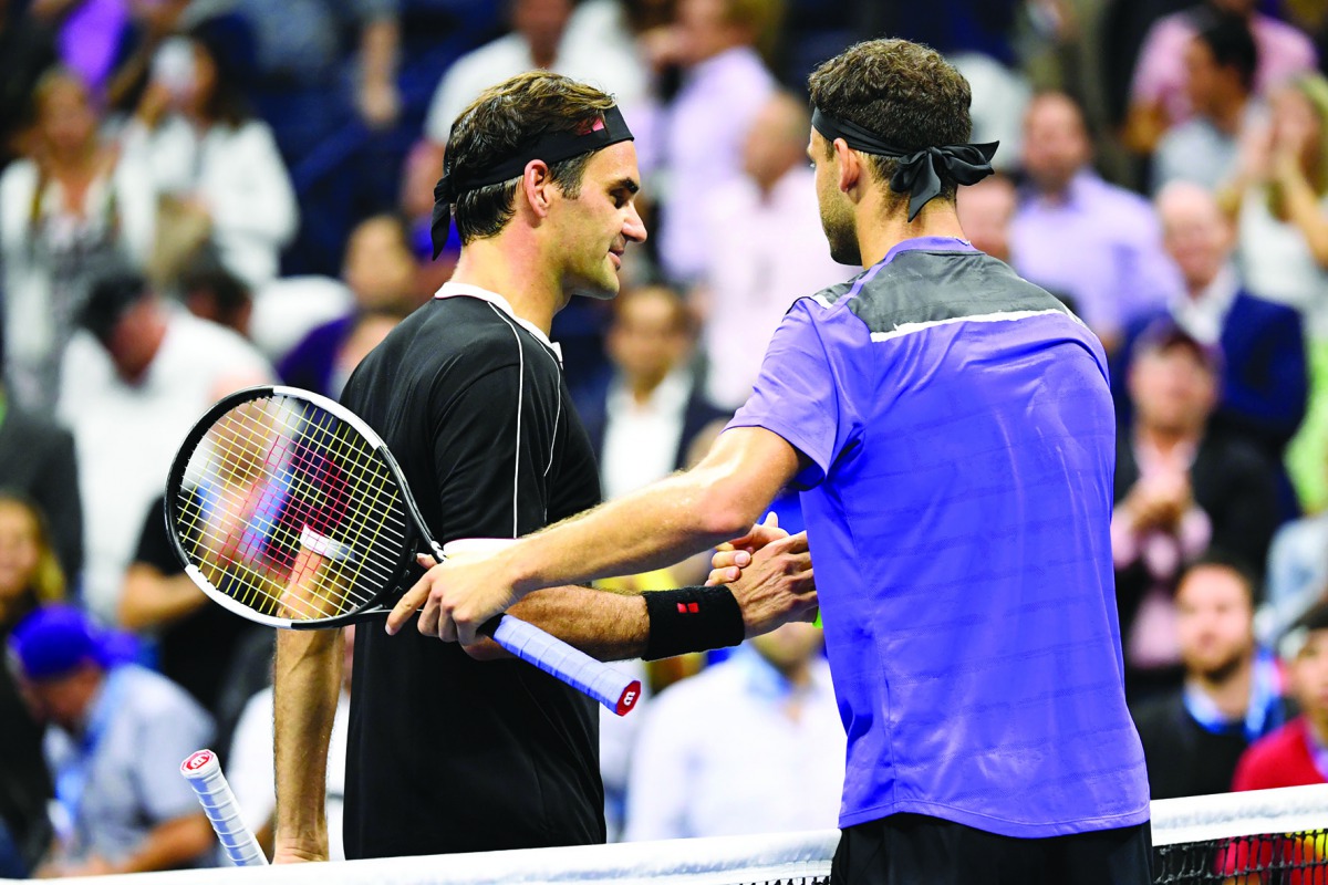 Roger Federer of Switzerland, left, and Grigor Dimitrov of Bulgaria shake hands after Dimitrov wins the quarterfinal match on day nine of the 2019 US Open tennis tournament at USTA Billie Jean King National Tennis Center. Credit: Danielle Parhizkaran-USA 