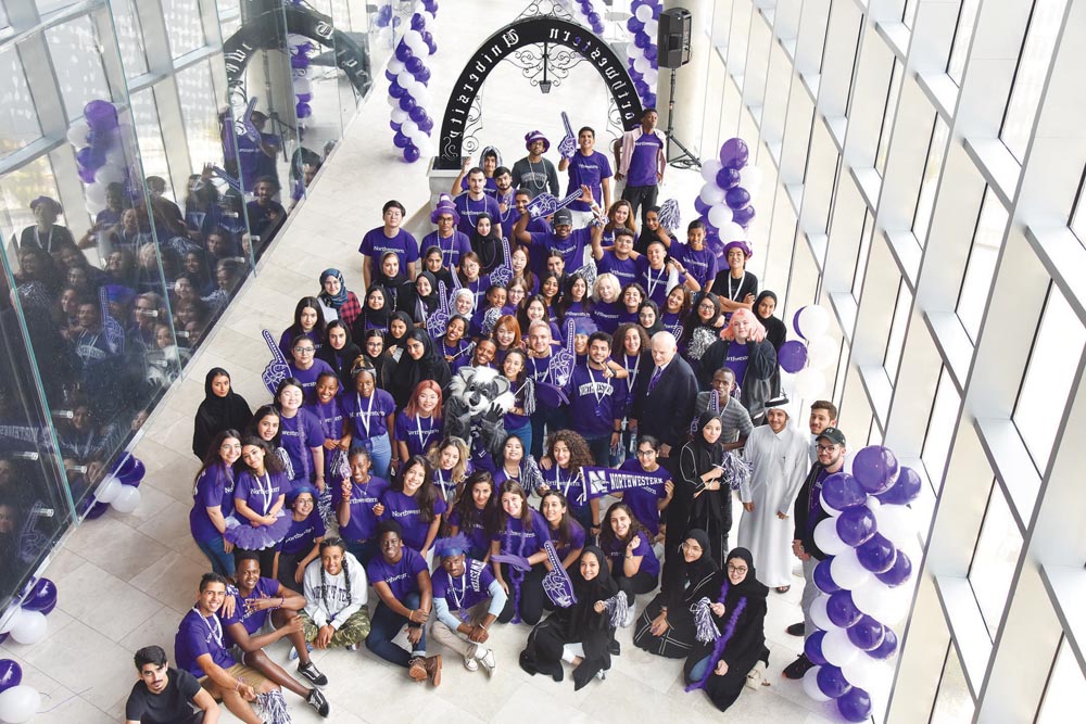 NU-Q’s incoming Class of 123 students join Dean Everette E Dennis after participating in Northwestern’s March Through the Arch tradition.