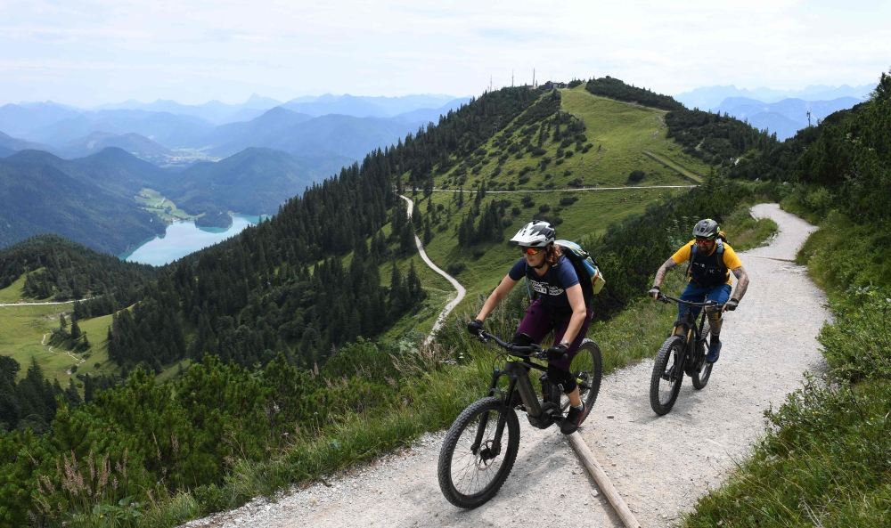 (FILES) This file photo taken on August 5, 2019 shows Ursula and Robert Werner cycling on their electric bikes as they are on their way up to the Herzogstand mountain in the Alp mountains near the village Walchensee, southern Germany. AFP / Christof Stach