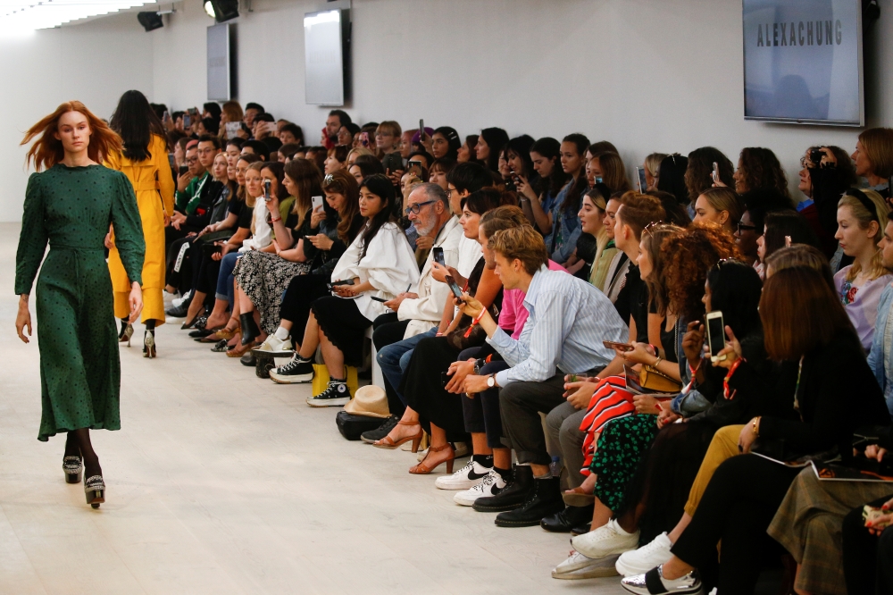 Members of the public watch models present creations at the Alexa Chung public catwalk show during London Fashion Week in London, Britain, September 14, 2019. REUTERS/ Henry Nicholls