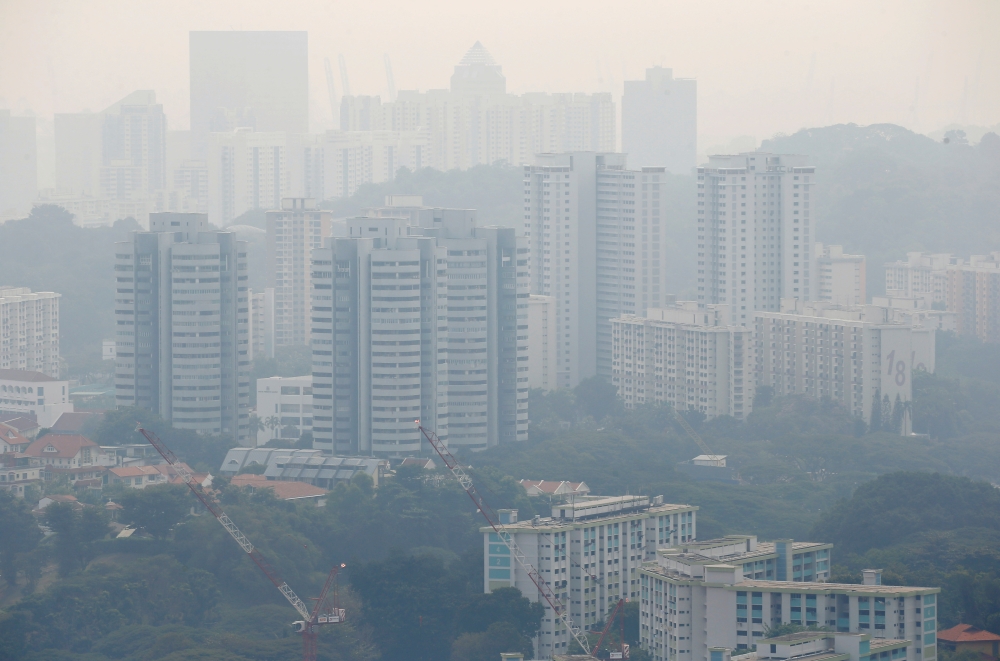 FILE PHOTO: Public housing apartment blocks are shrouded by haze in Singapore September 13, 2019. REUTERS/Feline Lim