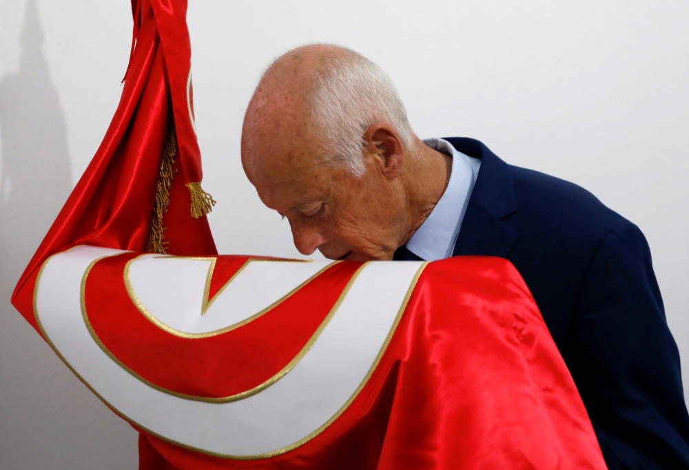 Presidential candidate Kais Saied kisses a Tunisian flag after unofficial results during the Tunisian presidential election in Tunis, September 15, 2019. Reuters/Zoubeir Souissi