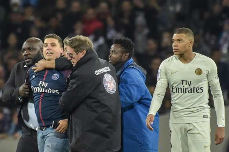 The fan seized his photo opportunity in added time at the end of the first half on 31 March with the match still goalless. AFP/Pascal Pavani