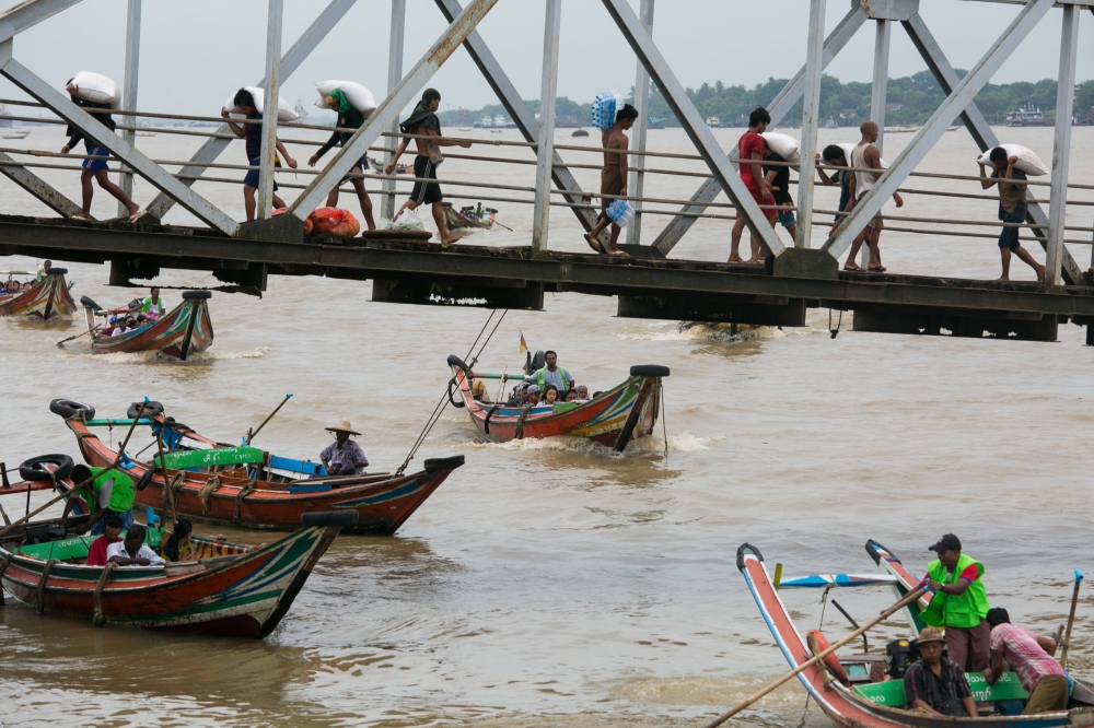 People from Dala township arriving by boat in Yangon after crossing the Yangon River. AFP / Sai Aung Main