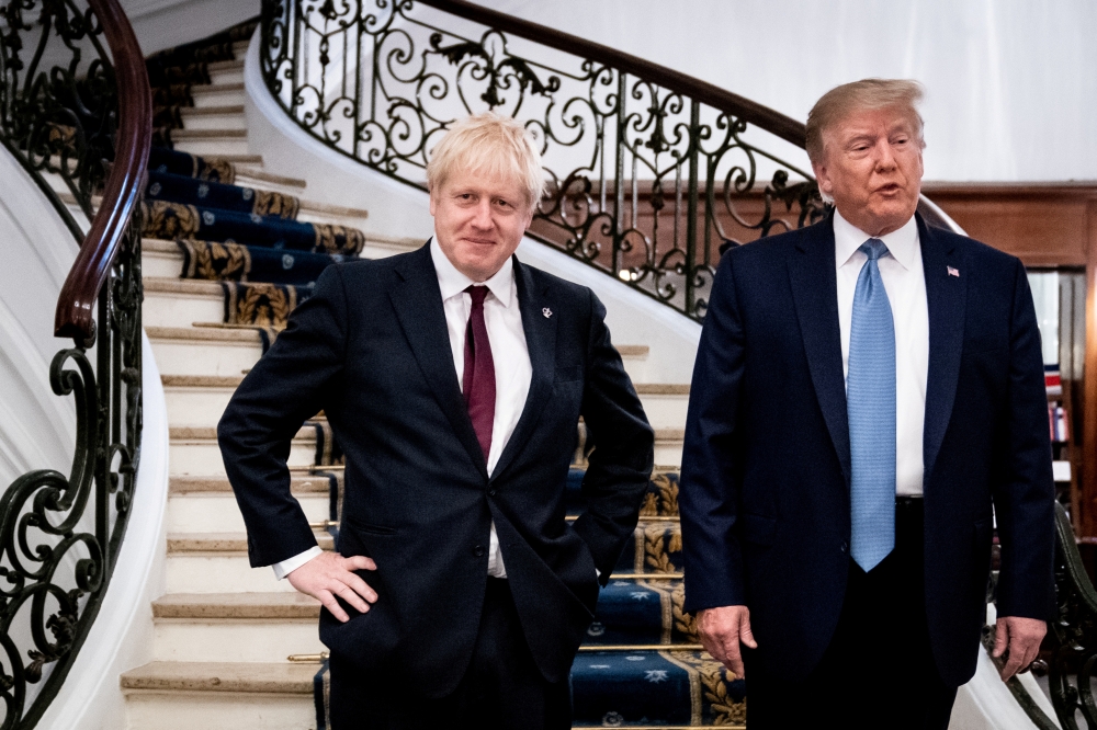 FILE PHOTO: U.S. President Donald Trump and Britain's Prime Minister Boris Johnson arrive for a bilateral meeting during the G7 summit in Biarritz, France, August 25, 2019. Erin Schaff/Pool via REUTERS/File Photo
