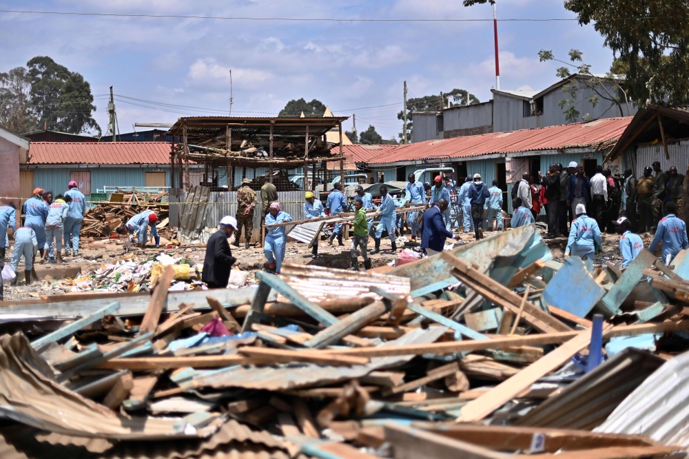 Rescuers are at work around a collapsed school building, on September 23, 2019 in Nairobi. AFP / TONY KARUMBA