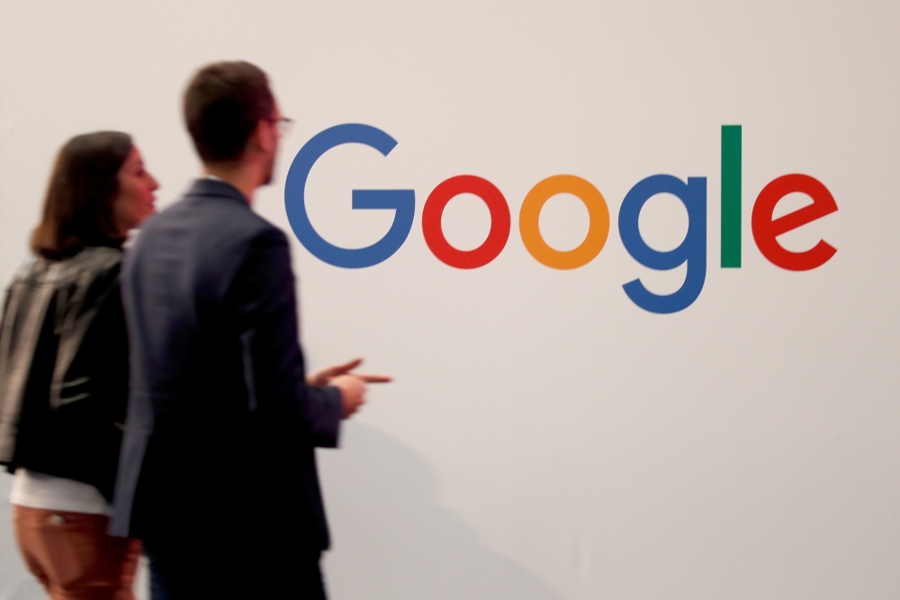 FILE PHOTO: Visitors pass by the logo of Google at the high profile startups and high tech leaders gathering, Viva Tech,in Paris, France May 16, 2019. REUTERS/Charles Platiau