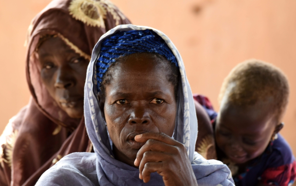 A family, who is among the 300,000 internally displaced because of jihadist violence in northern and eastern Burkina Faso, is pictured on September 17, 2019 in the village of Yagma near Ouagadougou. AFP / Issouf Sanogo 