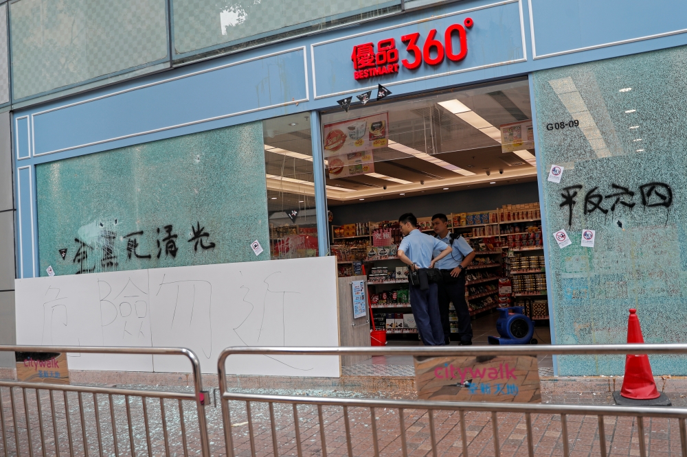 Policemen are seen in a vandalized store in Tsuen Wan, Hong Kong, China, October 2, 2019. REUTERS/Susana Vera