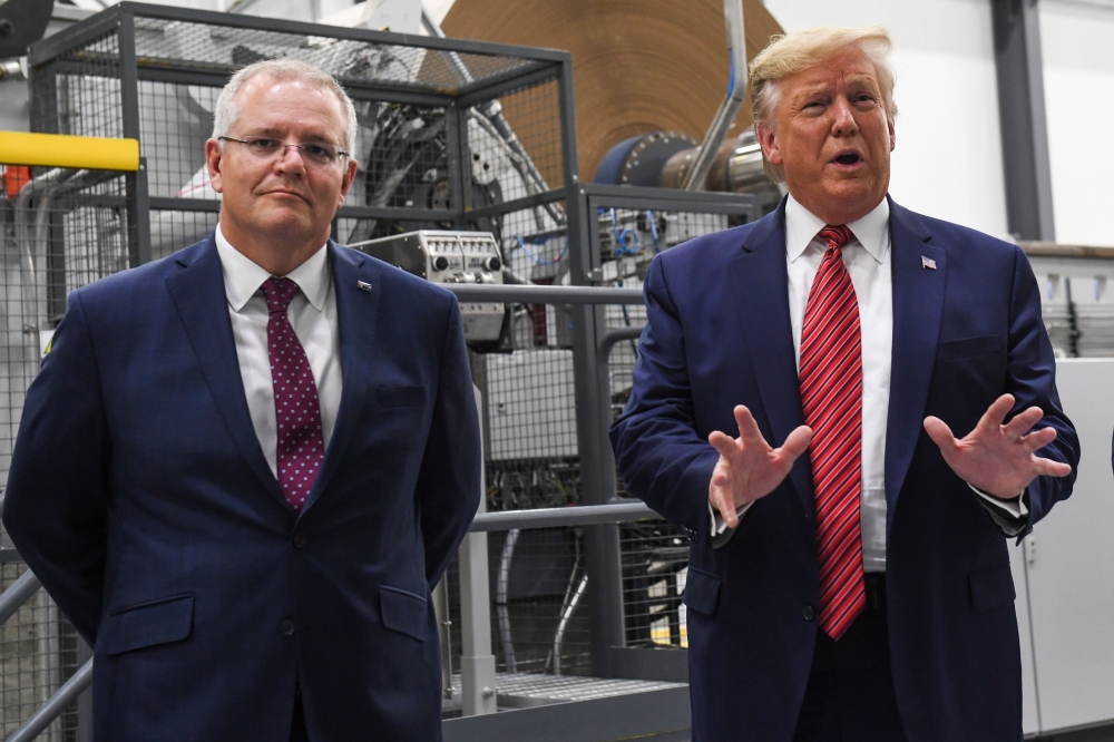 (FILES) In this file photo taken on September 22, 2019 US President Donald Trump speaks as Australian Prime Minister Scott Morrison looks on in a visit to Pratt Industries during the plant's opening in Wapakoneta, Ohio. AFP / SAUL LOEB