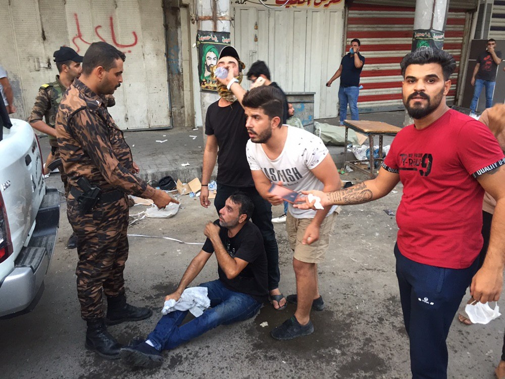 People gather to protest government due to corruption, unsolved unemployment issue and inadequate public service in Baghdad, Iraq on October 02, 2019. (Murtadha Sudani / Anadolu Agency)
 