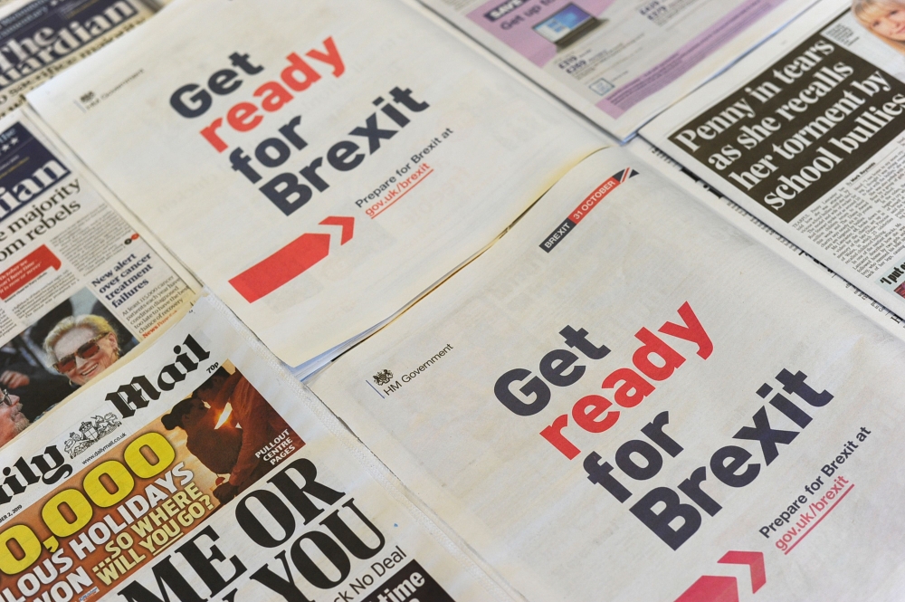 (FILES) In this file photo taken on September 02, 2019 an arrangement of newspapers photographed as an illustration in London on September 2, 2019, shows a full-page advertisement taken out by the UK Government in several daily newspapers as part of its p