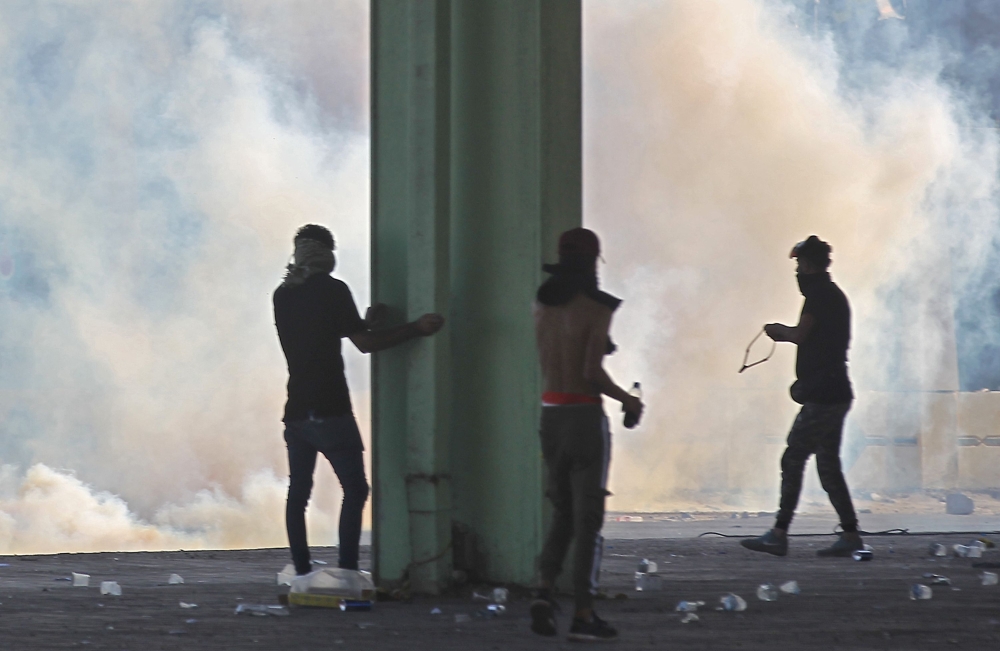 FILE PHOTO: Smoke rises from burning tyres during as Iraqis demonstrate against state corruption, failing public services and unemployment, in the Iraqi capital Baghdad on October 5, 2019.   AFP / AHMAD AL-RUBAYE
